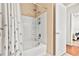 White shower-tub combination with shower head and storage shelves at 10764 70Th Ave # 6210, Seminole, FL 33772
