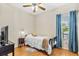 Cozy bedroom with a bed, ceiling fan, and window with curtains at 10764 70Th Ave # 6210, Seminole, FL 33772