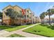 Beautiful condo building with multiple floors, palm trees, and a well-maintained lawn and sidewalk at 10764 70Th Ave # 6210, Seminole, FL 33772