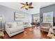 Living room featuring hardwood floors, a ceiling fan, and views into the dining area at 10764 70Th Ave # 6210, Seminole, FL 33772