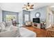 Bright living room with hardwood floors, a ceiling fan, and views to the outside balcony at 10764 70Th Ave # 6210, Seminole, FL 33772