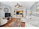 Living room that opens to the kitchen with breakfast bar, hardwood floors, and blue accent wall at 10764 70Th Ave # 6210, Seminole, FL 33772