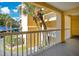 View from a condo balcony with a lush, tropical outdoor scenery featuring palm trees and bright blue sky at 1125 Pinellas Bayway S # 103, Tierra Verde, FL 33715