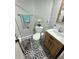 Stylish bathroom features a modern vanity, eye-catching patterned floor tiles, and a gray accent wall at 1125 Pinellas Bayway S # 103, Tierra Verde, FL 33715
