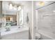 Bright bathroom featuring a white vanity, a toilet, and a shower with white tile at 1125 Pinellas Bayway S # 103, Tierra Verde, FL 33715