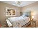 Cozy bedroom featuring a twin bed with a beach-themed quilt, a small nightstand, and a window at 1125 Pinellas Bayway S # 103, Tierra Verde, FL 33715