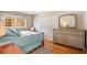 Tranquil bedroom showcasing a cozy queen bed, a dresser with a mirror, and natural light at 1125 Pinellas Bayway S # 103, Tierra Verde, FL 33715