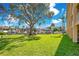 Lush grassy grounds boast mature trees offering shade and picturesque views of the marina and boats at 1125 Pinellas Bayway S # 103, Tierra Verde, FL 33715