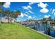 Serene waterfront views showcasing lush green lawns, boat docks, and palm trees creating a tropical oasis at 1125 Pinellas Bayway S # 103, Tierra Verde, FL 33715