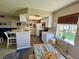 Bright kitchen with white cabinets, modern appliances, and a cozy dining area, perfect for enjoying meals with a view at 1125 Pinellas Bayway S # 103, Tierra Verde, FL 33715