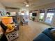 Bright living room showcasing an open floor plan, a comfortable blue sofa, and access to a dining area at 1125 Pinellas Bayway S # 103, Tierra Verde, FL 33715