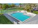Community pool with lounge chairs and manicured landscaping at 1125 Pinellas Bayway S # 103, Tierra Verde, FL 33715