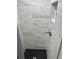 Modern shower with marble-look tiles and black hexagon floor at 1125 Pinellas Bayway S # 103, Tierra Verde, FL 33715