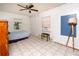 Bedroom with tile floors, natural light, ceiling fan, and space for a queen bed at 1144 7Th Nw St, Largo, FL 33770