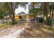 Exterior view of a yellow home surrounded by a chainlink fence, enhancing privacy and security at 1144 7Th Nw St, Largo, FL 33770