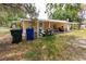 Exterior showcasing a yellow home with a covered area, providing shade and shelter for vehicles and outdoor activities at 1144 7Th Nw St, Largo, FL 33770