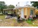 Yellow home featuring a covered carport and an entrance, offering outdoor living and parking solutions at 1144 7Th Nw St, Largo, FL 33770