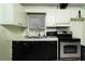 Kitchen with stainless steel appliances and black cabinetry at 1144 7Th Nw St, Largo, FL 33770