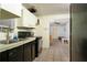 A kitchen with appliances, contrasting cabinets, and tile flooring provides functional space at 1144 7Th Nw St, Largo, FL 33770