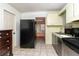 A kitchen features appliances, cabinets, and tile flooring for functionality and convenience at 1144 7Th Nw St, Largo, FL 33770