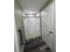 Bathroom showcases a stylish shower curtain, modern flooring, and ample space at 11889 Walker Ave, Seminole, FL 33772