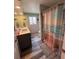 Bathroom with dual sinks, luxury vinyl floors, updated lighting and an ocean-themed shower curtain at 11889 Walker Ave, Seminole, FL 33772