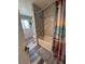 Bathroom with shower and tub, luxury vinyl floors, tiled walls and updated lighting at 11889 Walker Ave, Seminole, FL 33772