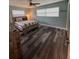 This bedroom features two windows with blinds, wood-look floors and neutral paint at 11889 Walker Ave, Seminole, FL 33772