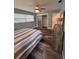 The bedroom features sleek window blinds and wood-look flooring, with sliding closet doors at 11889 Walker Ave, Seminole, FL 33772
