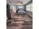 Inviting bedroom features a ceiling fan, wood-look floors, and ample natural light at 11889 Walker Ave, Seminole, FL 33772