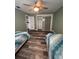 Bedroom with luxury vinyl floors, two beds, and ample closet space at 11889 Walker Ave, Seminole, FL 33772