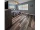 Bedroom features a ceiling fan, wood-look floors, and large windows for natural light at 11889 Walker Ave, Seminole, FL 33772