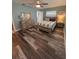 This bedroom features a wooden bed frame and matching dresser, and wood-look flooring at 11889 Walker Ave, Seminole, FL 33772
