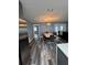 Dining room features a modern light fixture, stylish wood-look floors, and an adjacent living area at 11889 Walker Ave, Seminole, FL 33772