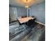 Dining area features a modern table with seating for six and attractive flooring at 11889 Walker Ave, Seminole, FL 33772