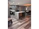 Well-equipped kitchen featuring gray cabinets, stainless steel appliances, and a quartz countertop island at 11889 Walker Ave, Seminole, FL 33772