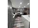 Well-equipped kitchen featuring gray cabinets, stainless steel appliances, and a quartz countertop island at 11889 Walker Ave, Seminole, FL 33772