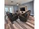 Comfortable living room featuring dual recliners, luxury vinyl floors and an entertainment center at 11889 Walker Ave, Seminole, FL 33772