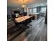 Open-concept living room with a dining area, luxury vinyl flooring, and modern furnishings at 11889 Walker Ave, Seminole, FL 33772