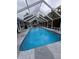 Relaxing screened-in pool with stone surround, perfect for enjoying the outdoors in comfort and style at 11889 Walker Ave, Seminole, FL 33772