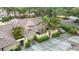 Aerial view of property showcasing roof, driveway, and surrounding mature trees and landscaping at 120 Colony South Dr, Tarpon Springs, FL 34689