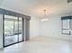 Dining room with tiled floors, neutral walls, and sliding glass door at 120 Colony South Dr, Tarpon Springs, FL 34689