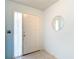 Bright entryway with tile floors, a decorative mirror, and natural light streaming through the side window at 120 Colony South Dr, Tarpon Springs, FL 34689