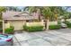 Beautiful home exterior with an attached garage, tidy landscaping, and a private walkway leading to the front door at 120 Colony South Dr, Tarpon Springs, FL 34689