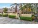 Inviting exterior showcasing manicured greenery, a private entrance, and an attached garage with convenient parking at 120 Colony South Dr, Tarpon Springs, FL 34689