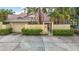 Charming exterior with a private courtyard, mature landscaping, and an attached garage at 120 Colony South Dr, Tarpon Springs, FL 34689