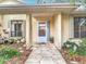 Inviting front porch with decorative stone walkway, complemented by lush landscaping and window boxes for added charm at 120 Colony South Dr, Tarpon Springs, FL 34689