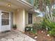 Charming front porch entrance with a decorative stone walkway and manicured landscaping, creating a welcoming appeal at 120 Colony South Dr, Tarpon Springs, FL 34689