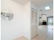 Hallway featuring tile floors, a decorative mirror, a closet and natural lighting from the skylight at 120 Colony South Dr, Tarpon Springs, FL 34689