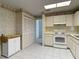Spacious kitchen with white cabinets and appliances at 120 Colony South Dr, Tarpon Springs, FL 34689